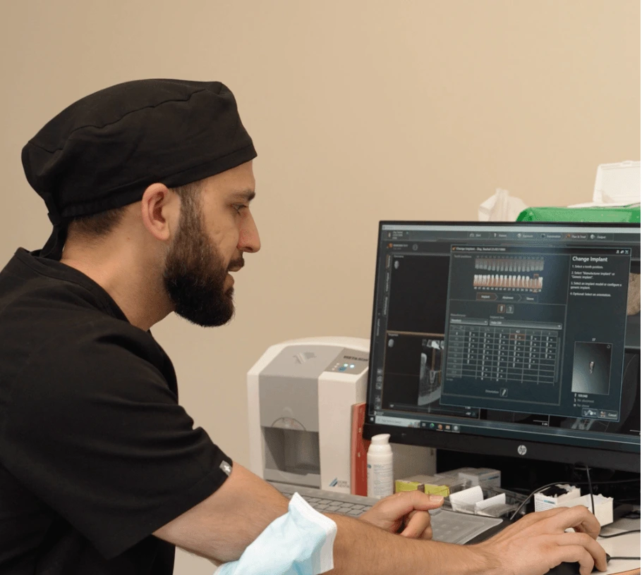 A woman showing something on a tablet to a man wearing a black cap and vest.