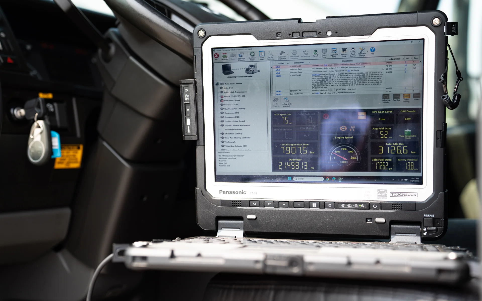Panasonic Toughbook laptop displaying vehicle diagnostics inside a truck cabin.