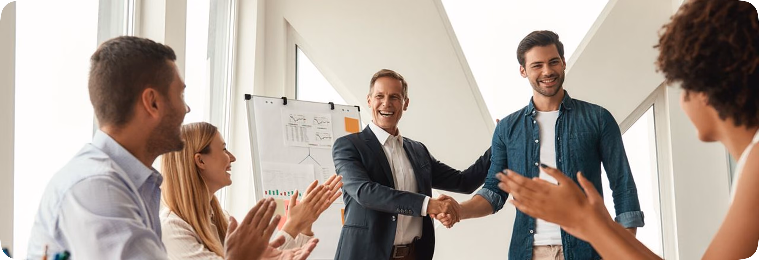 Business team applauding a new partnership handshake