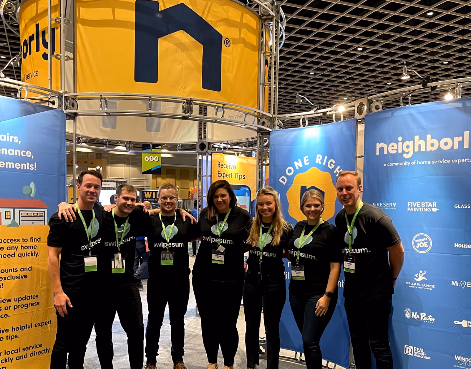 Swipesum team at the Neighborly booth