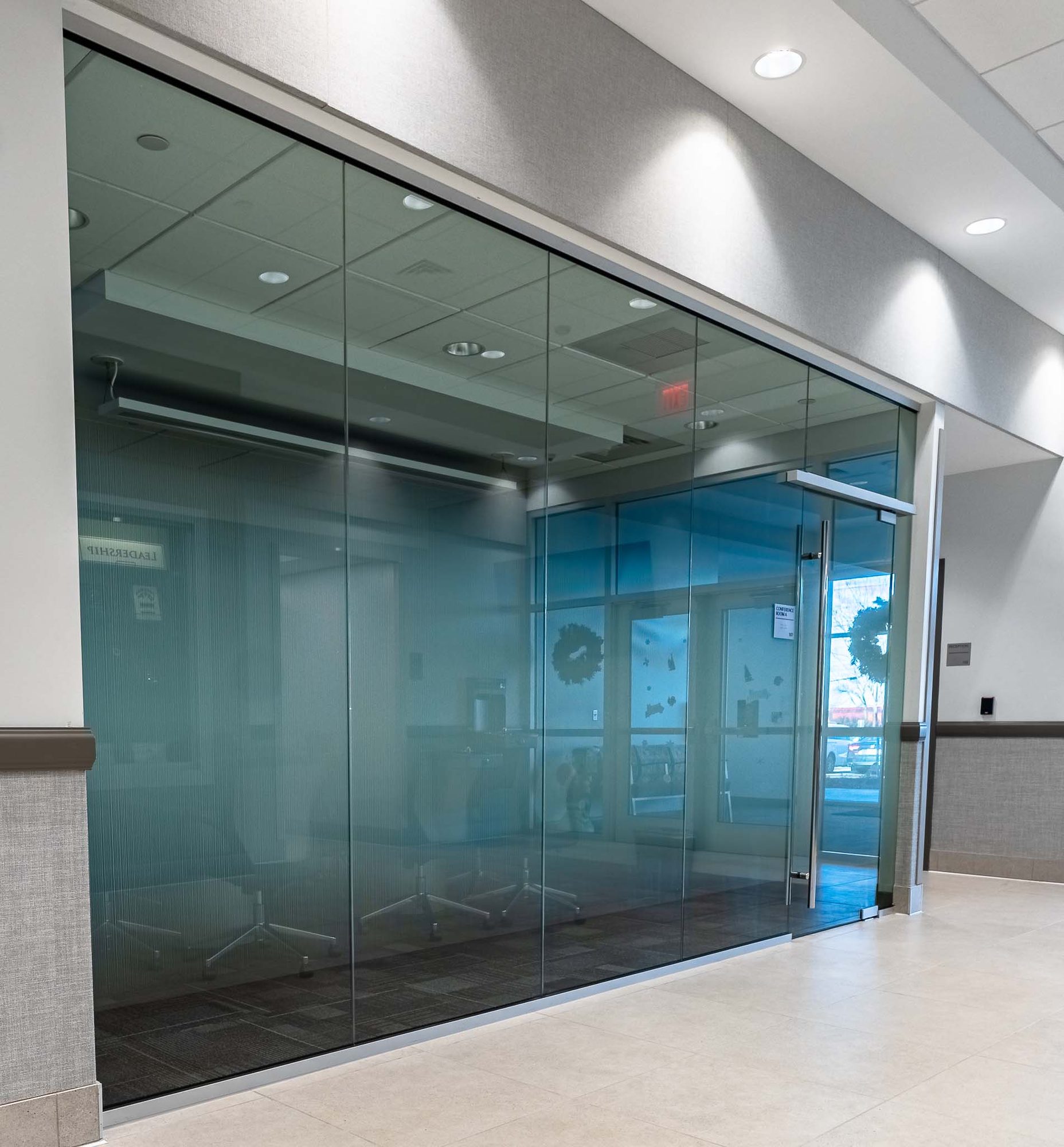 Interior heavy glass office front with U-channel glazing