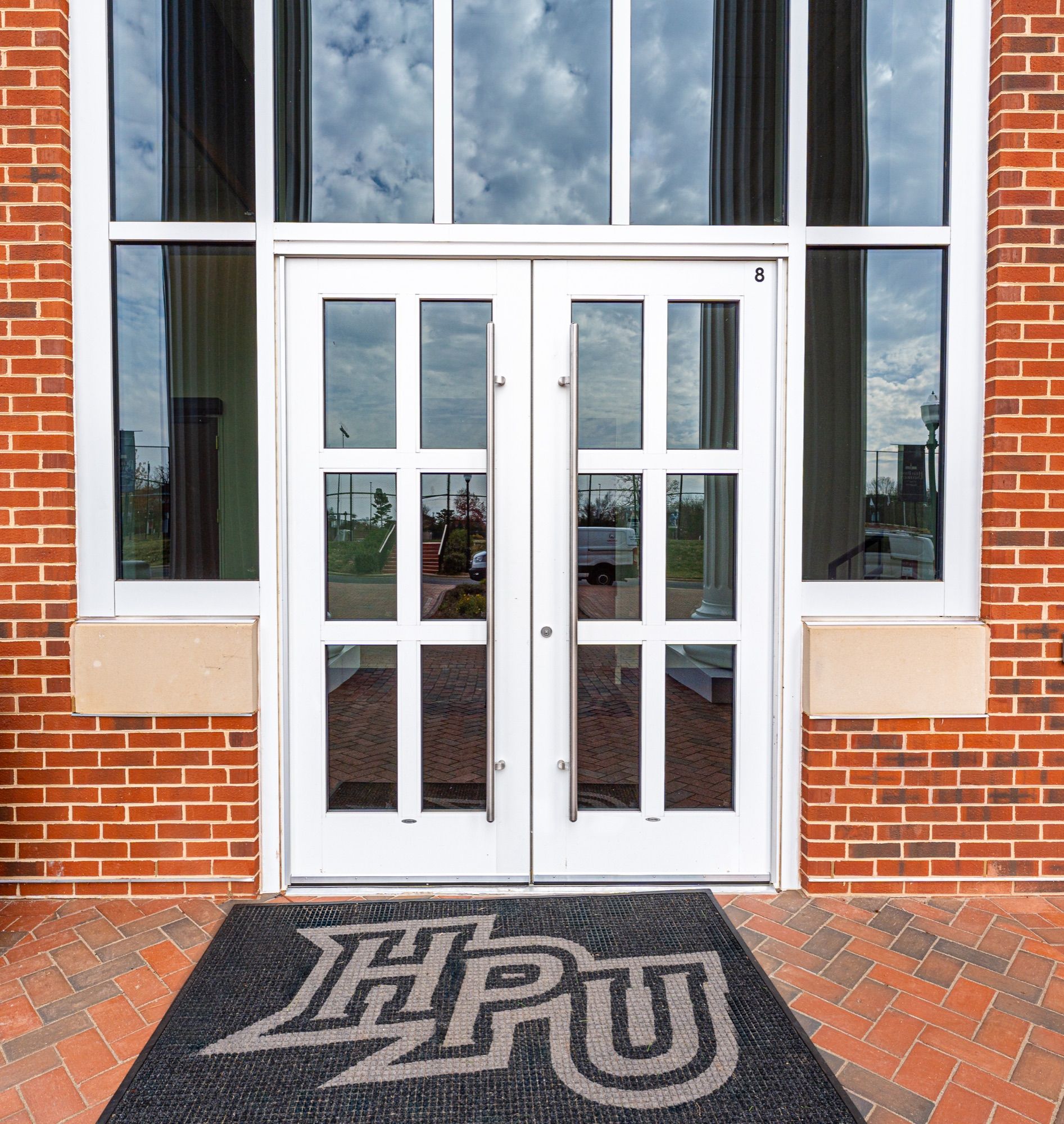 Aluminum entry doors with transom glazing above the HPU entry mat