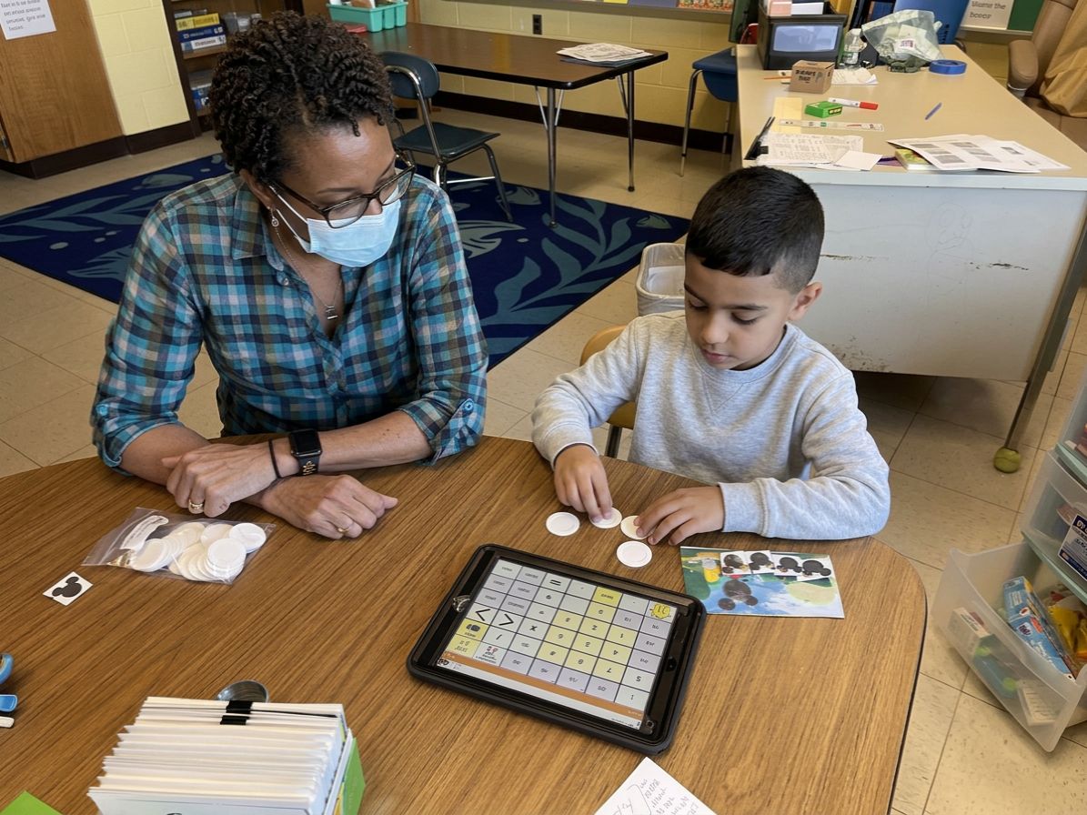 Teacher and student working.