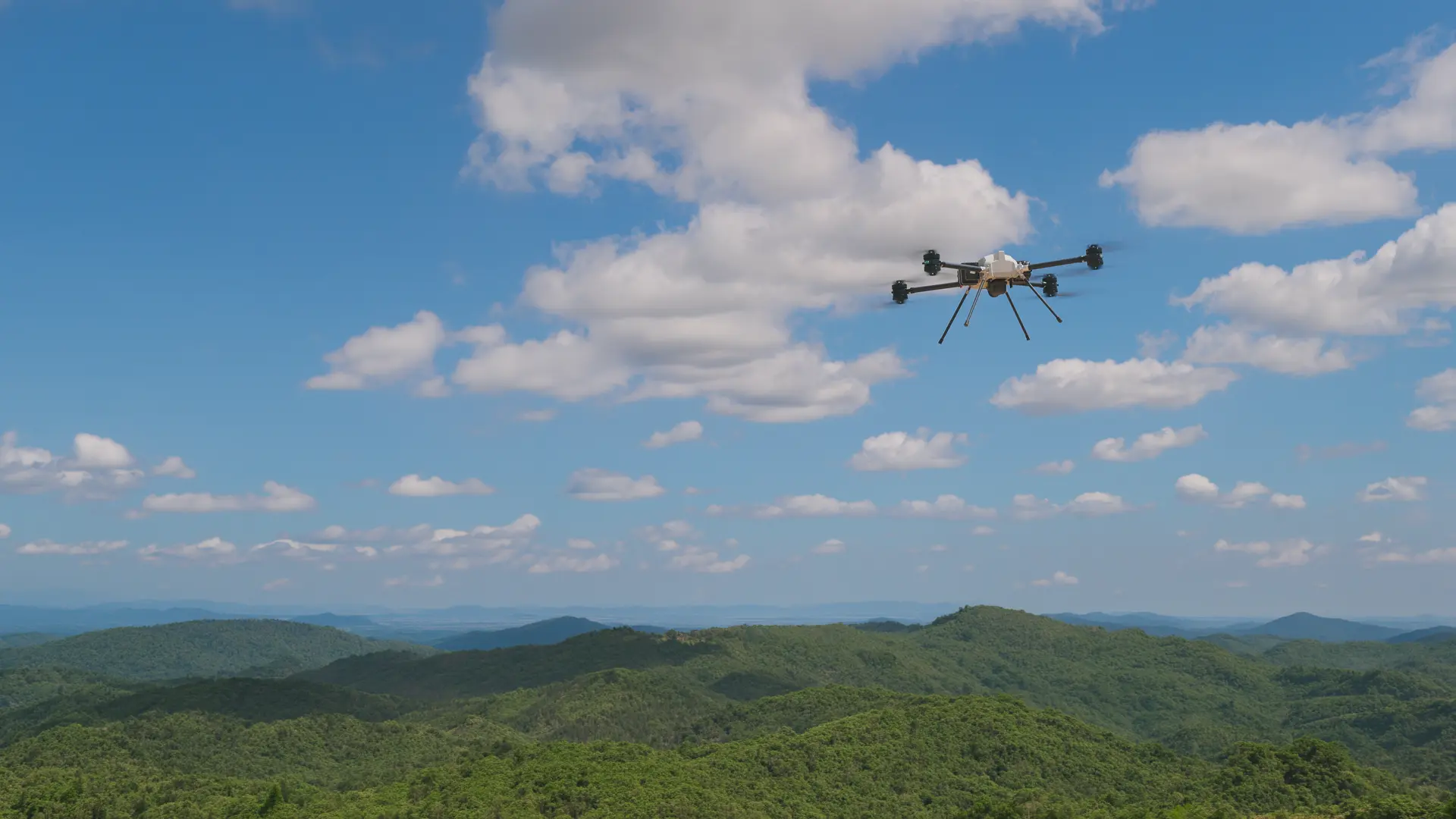 BVQ825 in flight high above forested hills under a blue sky scattered with cumulus clouds