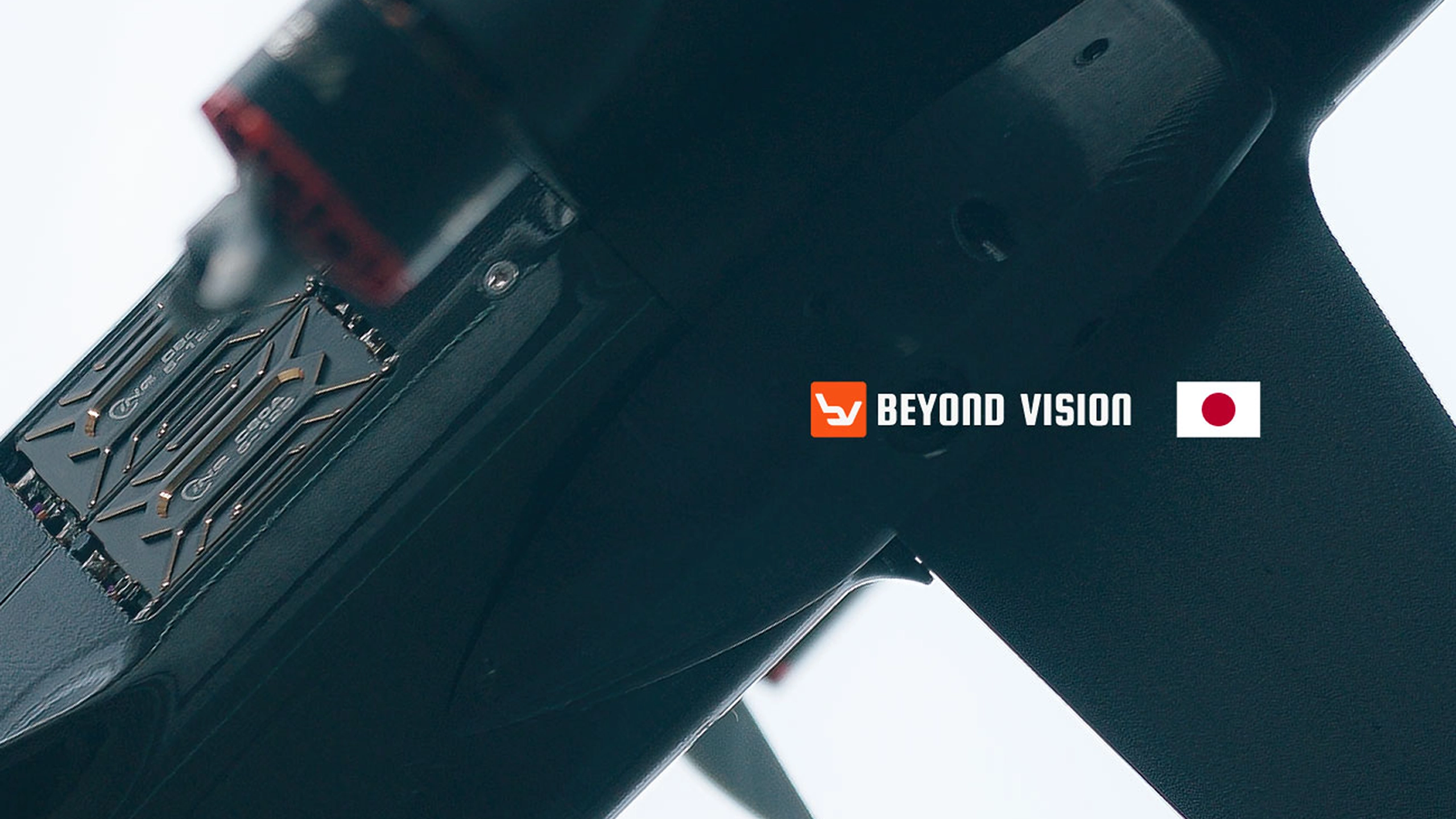 Close-up of a Beyond Vision interceptor drone airframe, with the Beyond Vision logo and the flag of Japan alongside.