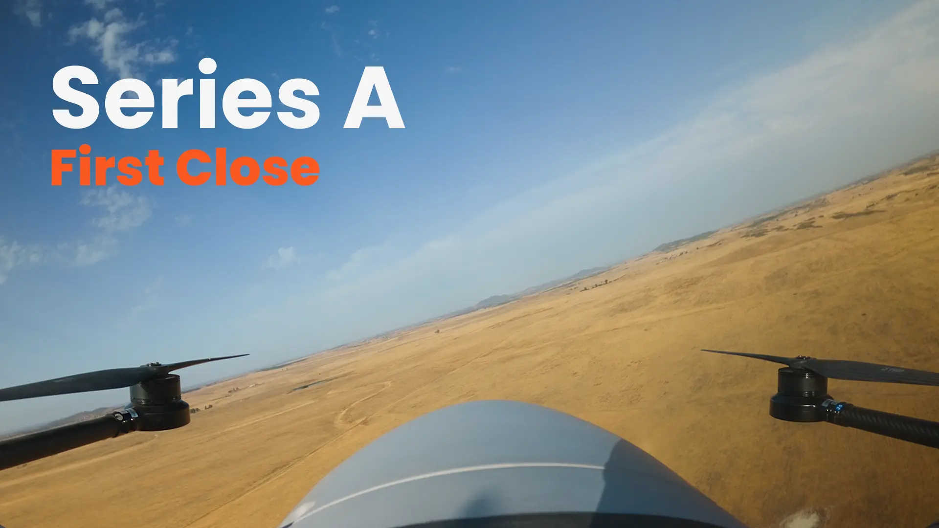 Onboard view from a Beyond Vision drone flying over dry open fields, with the words Series A, First Close.