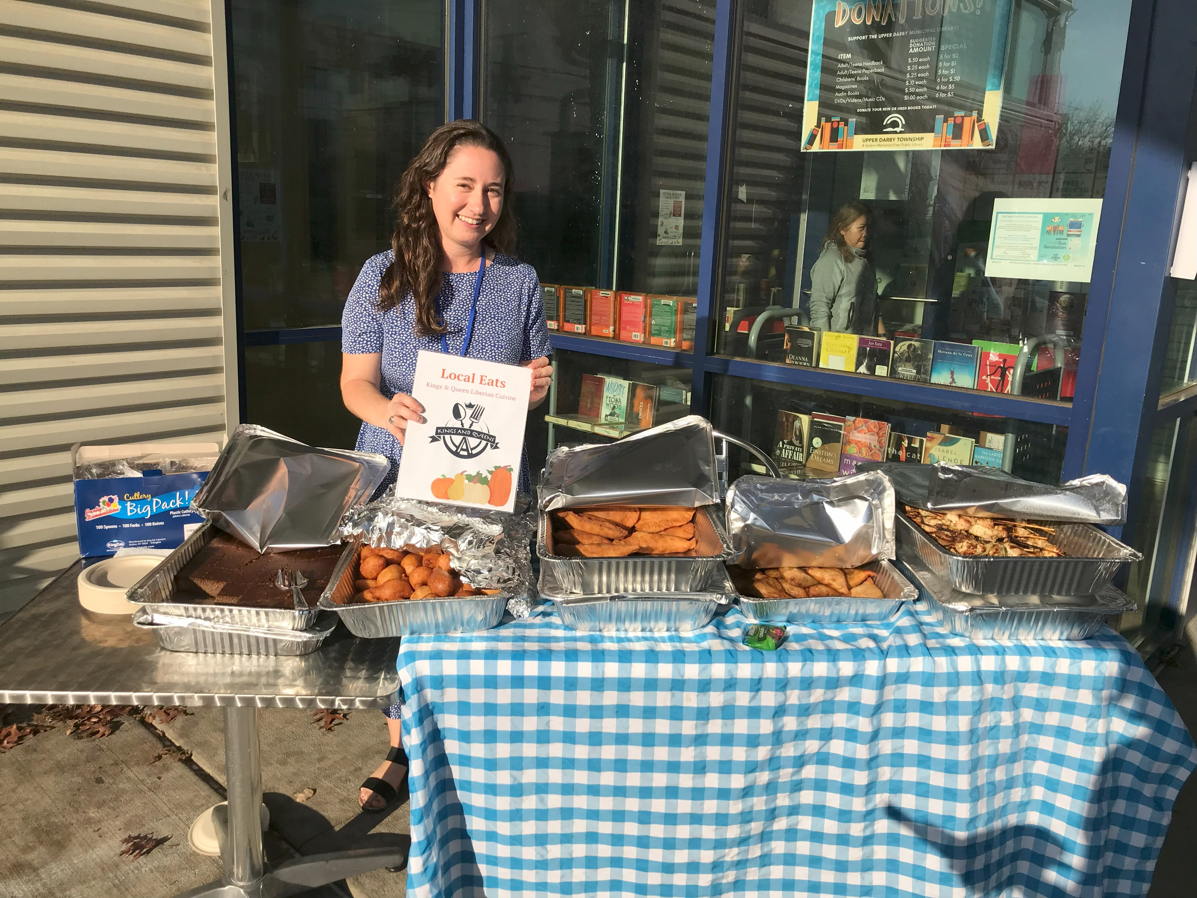 A woman stands at a table with catering
