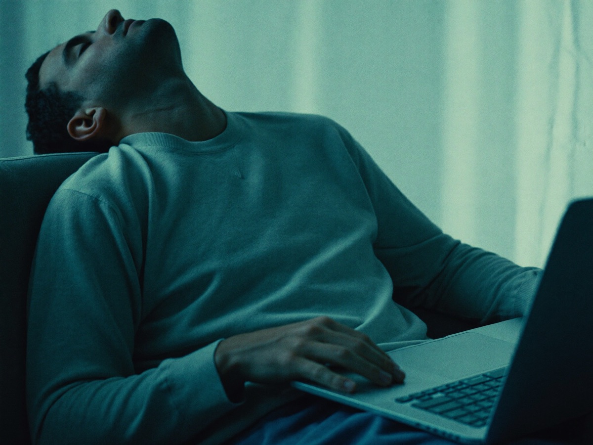 A man yawning at his desk