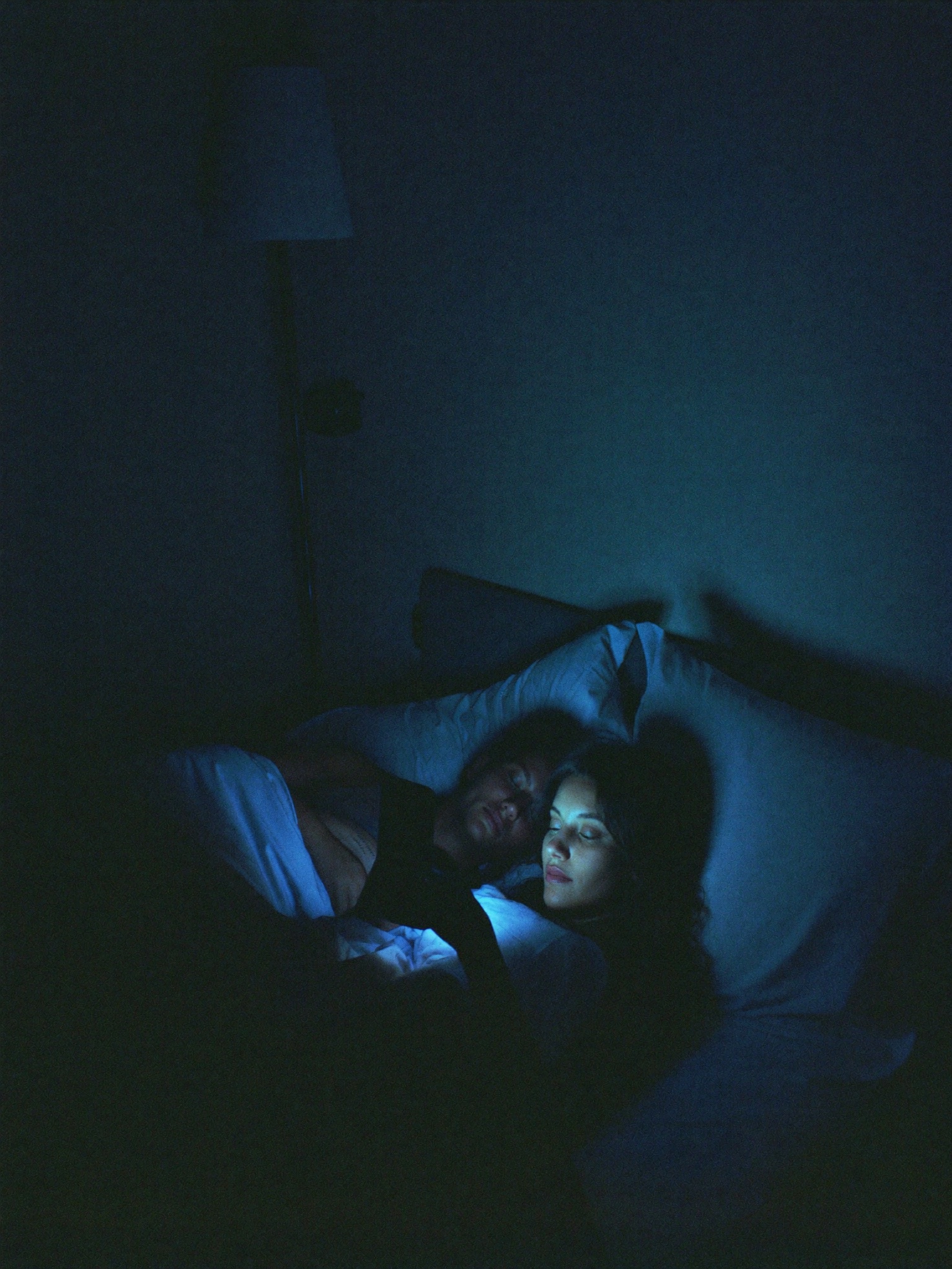 Woman awake at night while her partner sleeps