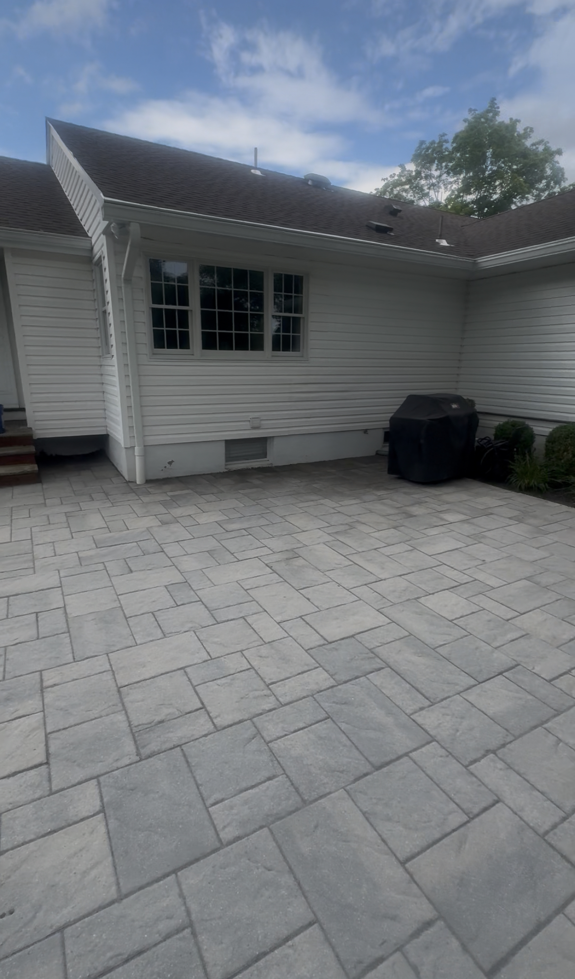 Clean stamped concrete driveway after stain removal