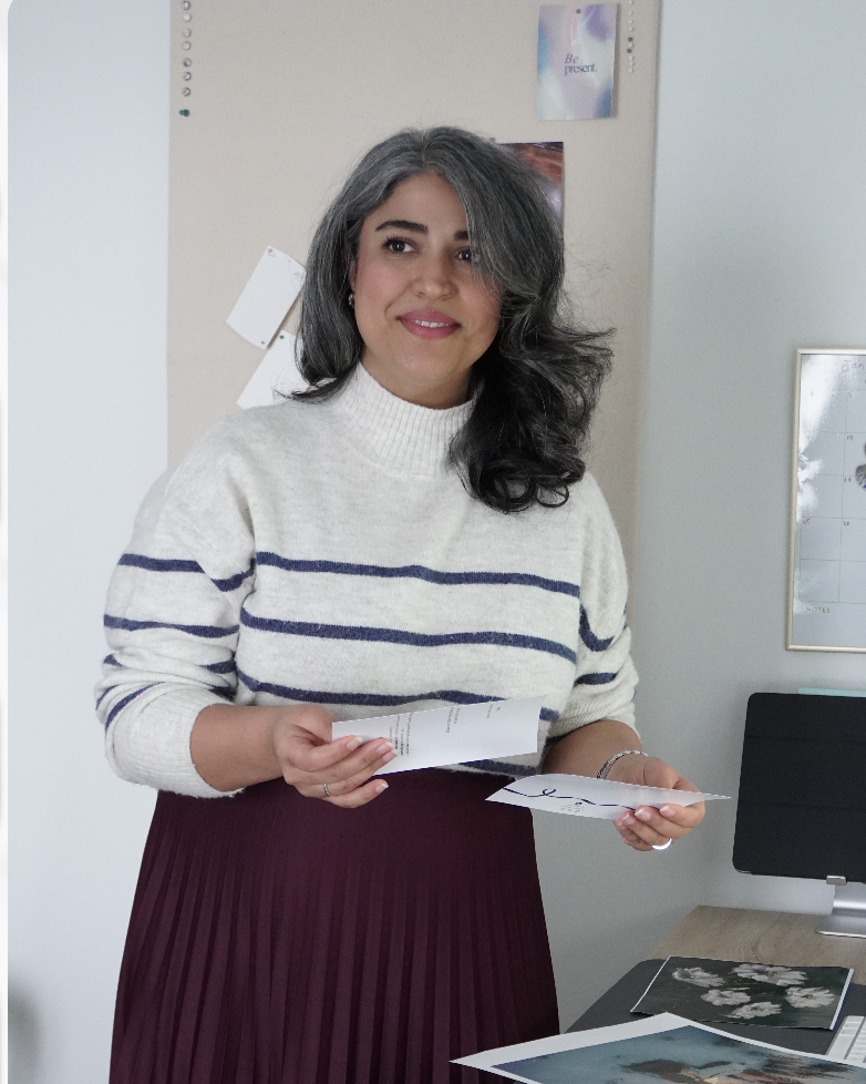 Yasaman Rasteh holding few cards and looking away