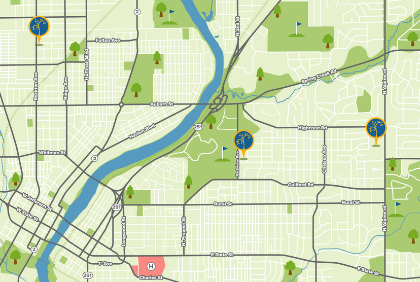 Map showing streets, green spaces, a river, and golf flags near Harlem Blvd and Auburn St.