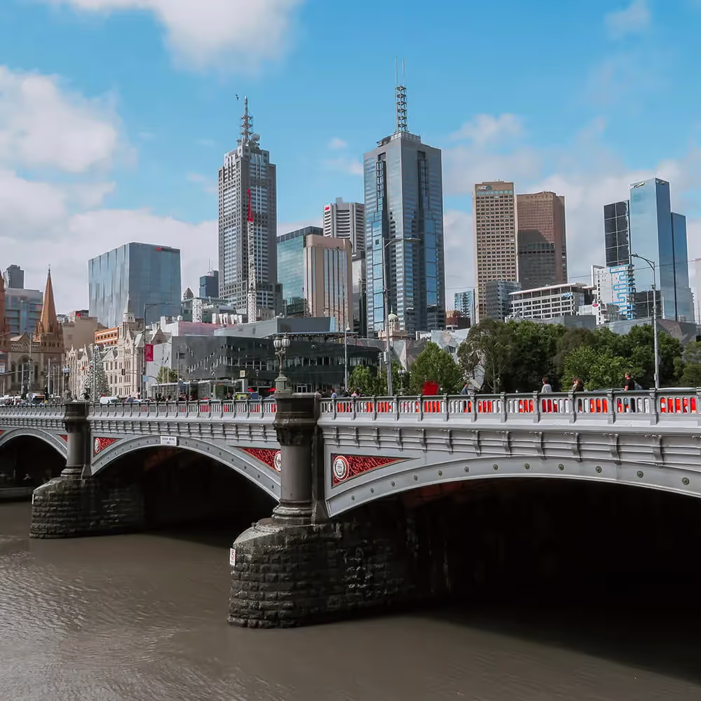 A view of Melbourne's CBD with a bridge in the foreground.