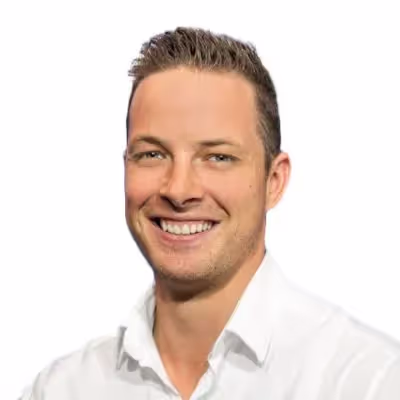 headshot of man smiling with a white background