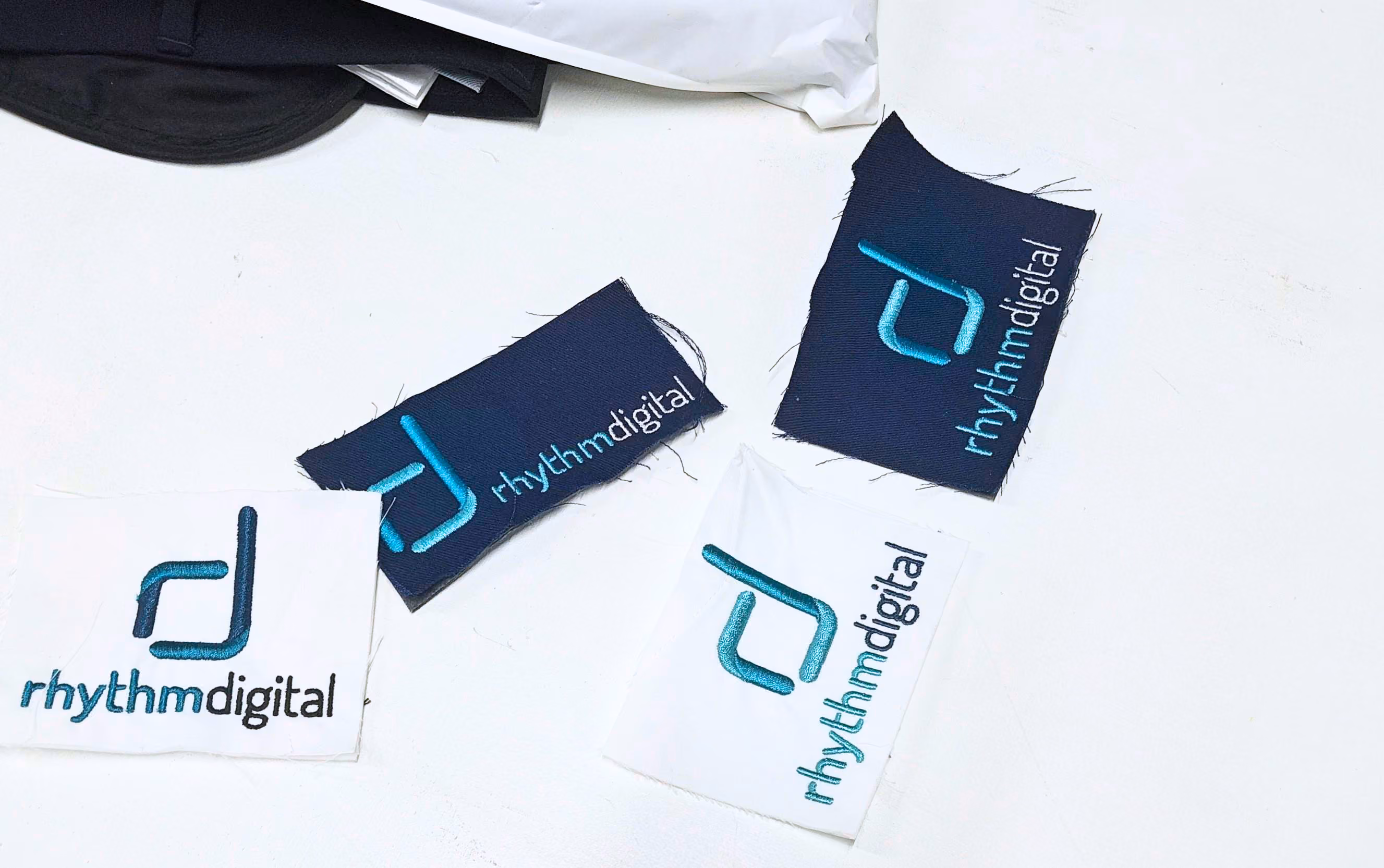 Stitch-offs made for Rhythm Digital, exploring the best placement and sizing for their logo embroidery and monogramming
