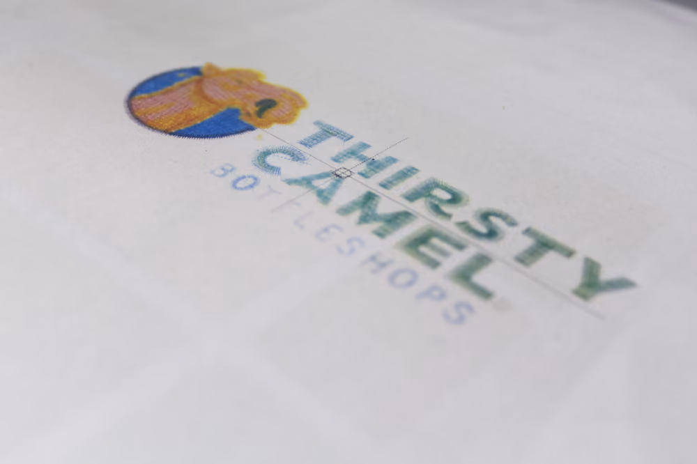 A print out of a logo in its embroidery file format, showing thread colours and stitch style