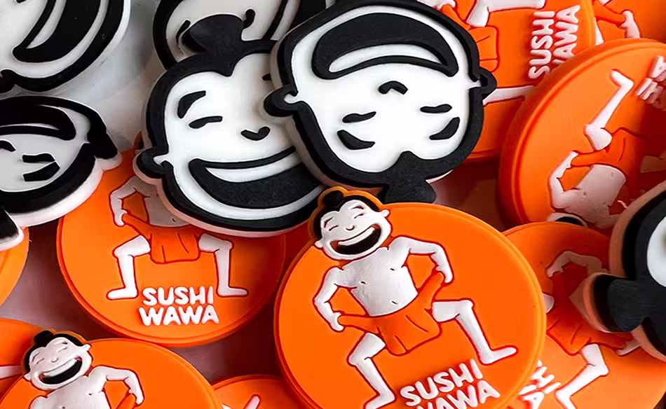 Orange and black Sushi Wawa tokens featuring a grinning character in a playful pose.