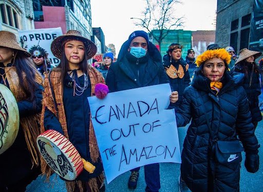 From left to right: Ta'Kaiya Blaney, land defender from the Tla’Amin Nation, unceded Coast Salish territory, British Columbia, Canada; Dinamam Tuxá, lawyer and APIB executive coordinator; and Puyr Tembé, President of FEPIPA and co-founder of Anmiga, marching in Montreal during COP15. Credits: Kamikia Kisedje/APIB