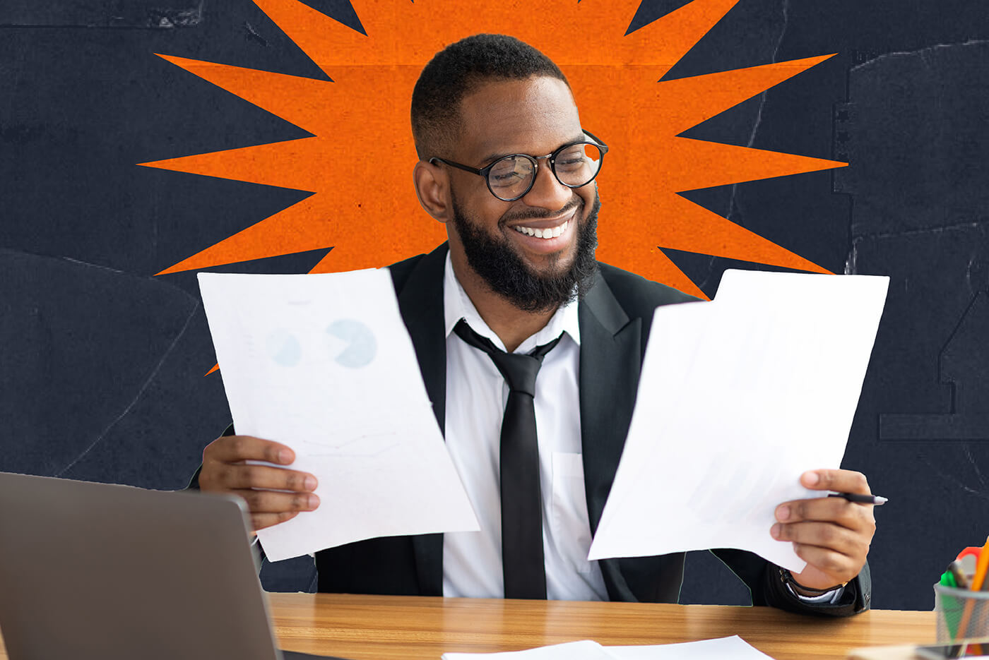 A man wearing glasses and a suit holds papers with some charts and statistics on them