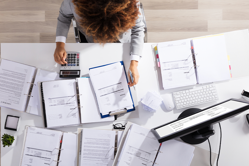 lawyer managing invoices and billing on her desk