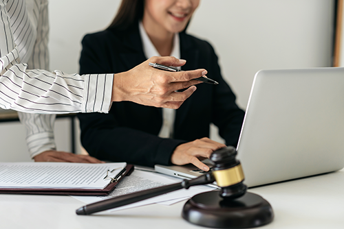 Woman works with client on computer