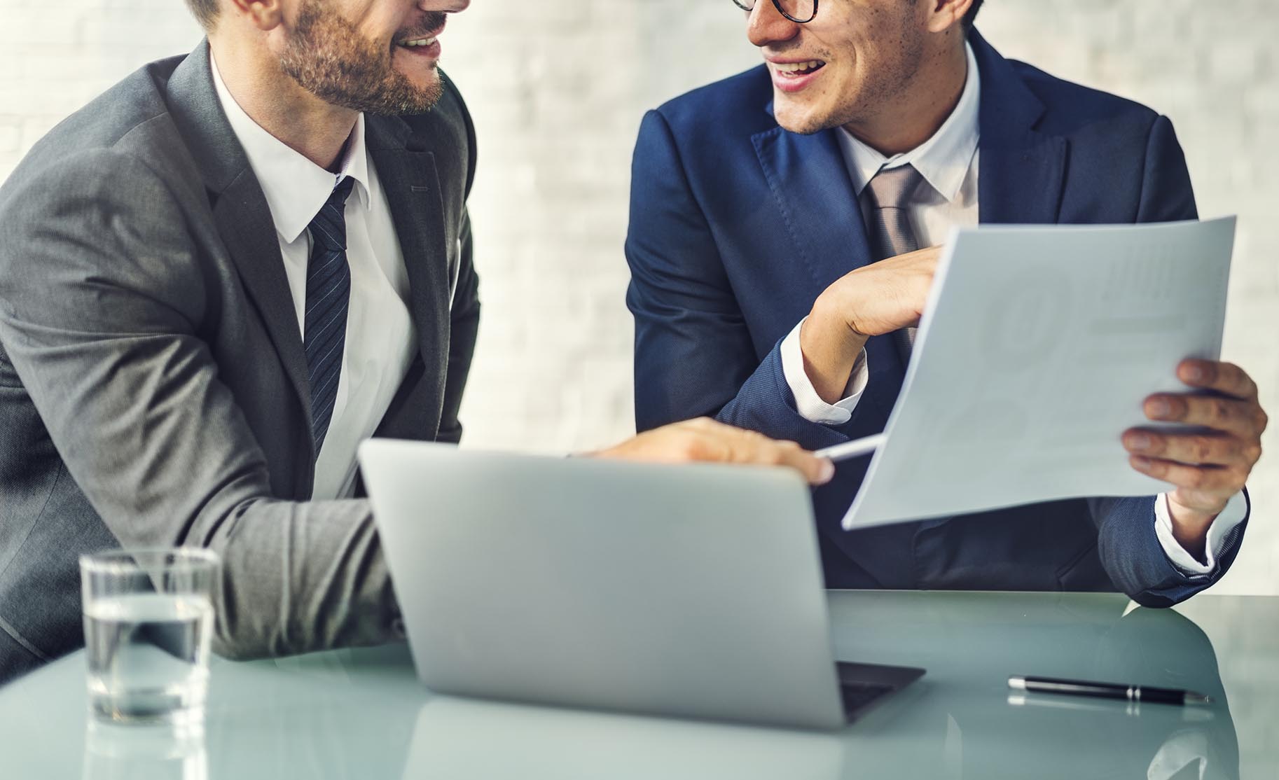 Two men working on a computer at a law firm