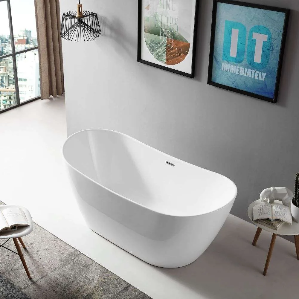 Oval freestanding bath in a bright room with framed prints and a black wire pendant