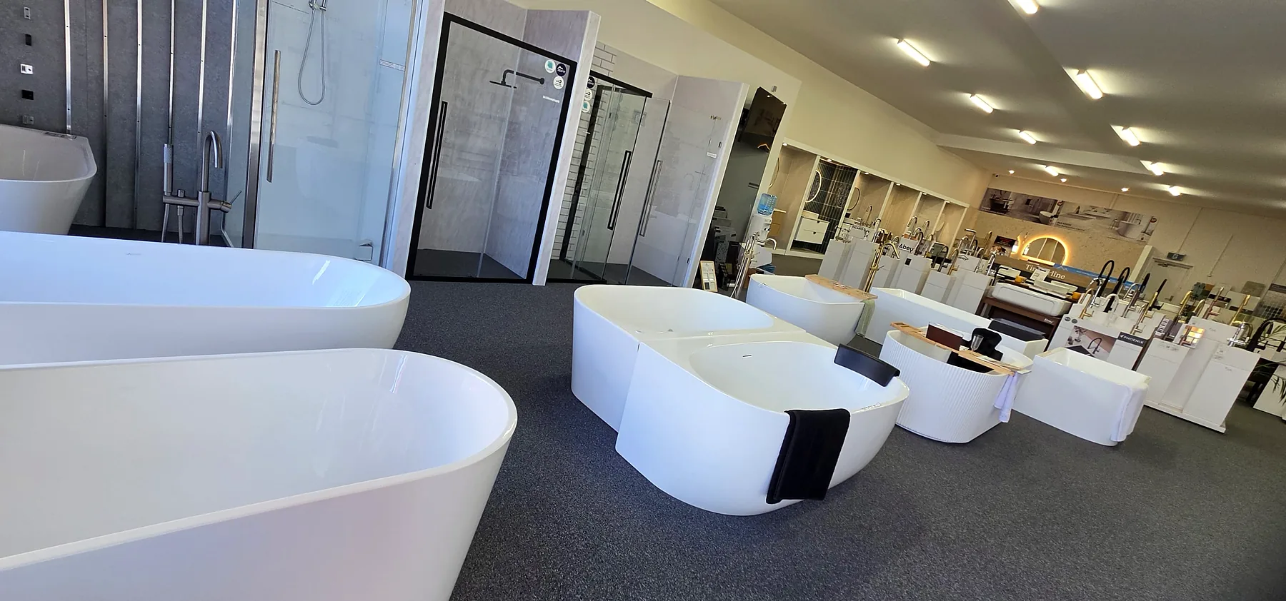 The Renovation Centre showroom floor at Osborne Park, looking down the length of the store past the freestanding baths