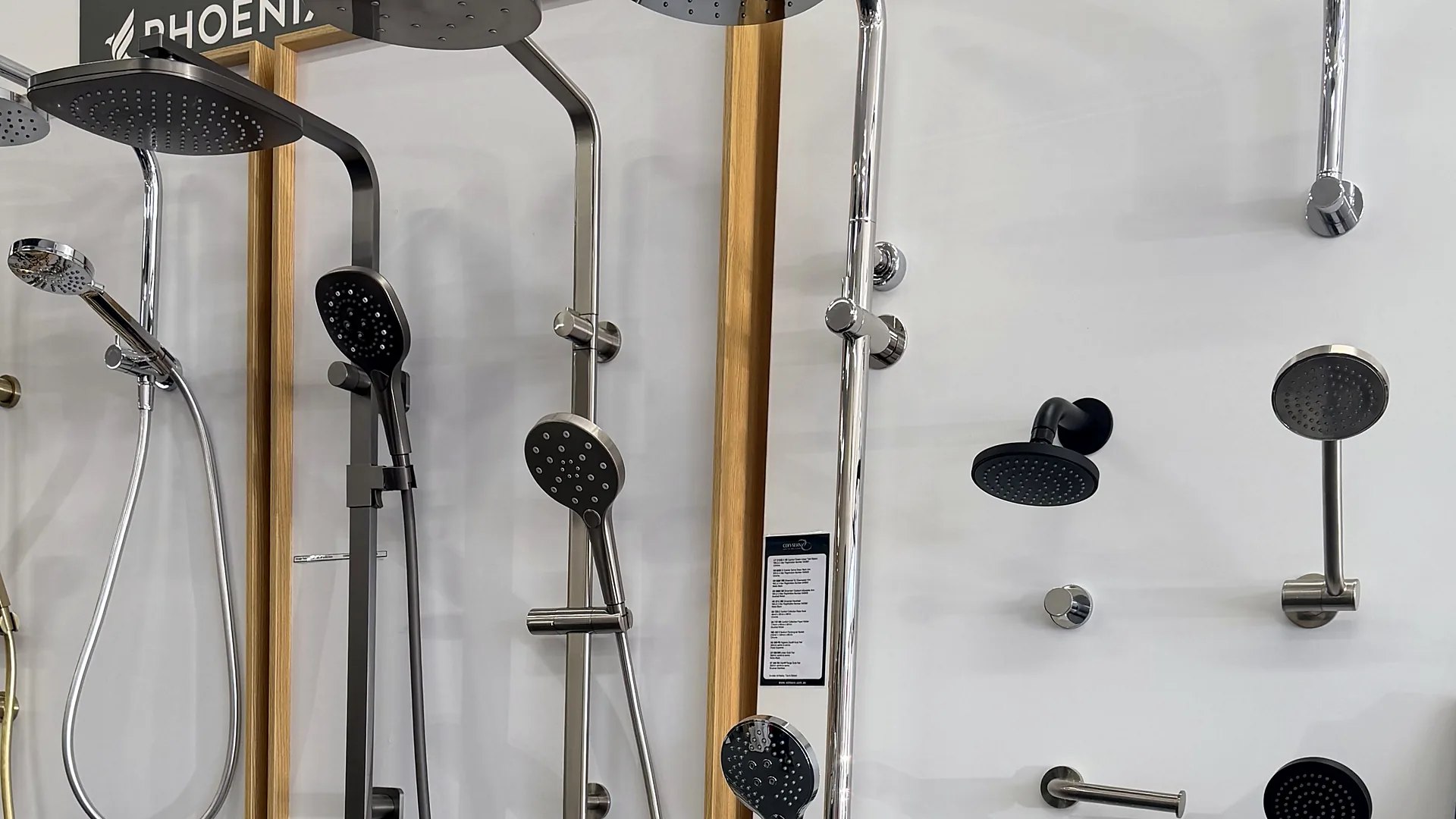 Shower display wall in the Osborne Park showroom with rain showers, hand showers on rails and wall mounted shower heads