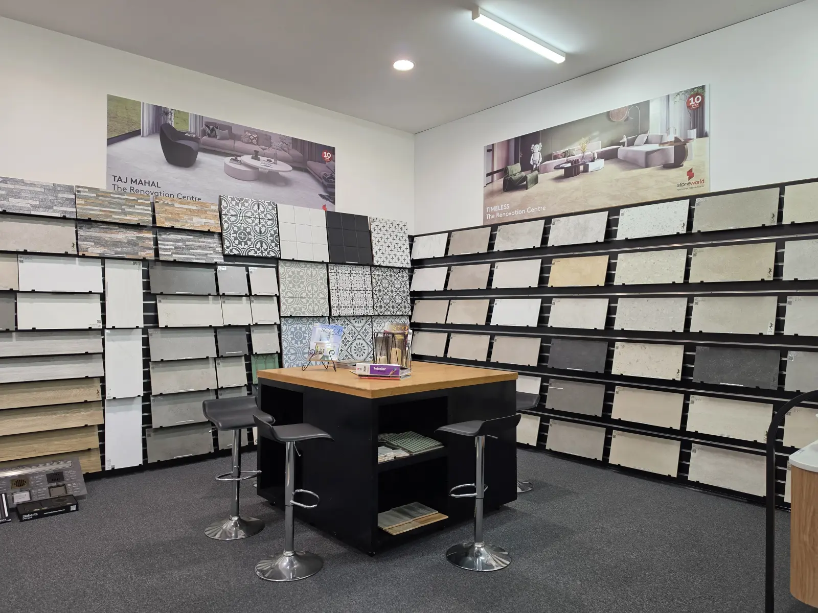The tile selection room at the Osborne Park showroom, with Stoneworld sample boards on the slat walls and the Stoneworld Taj Mahal and Timeless display graphics above