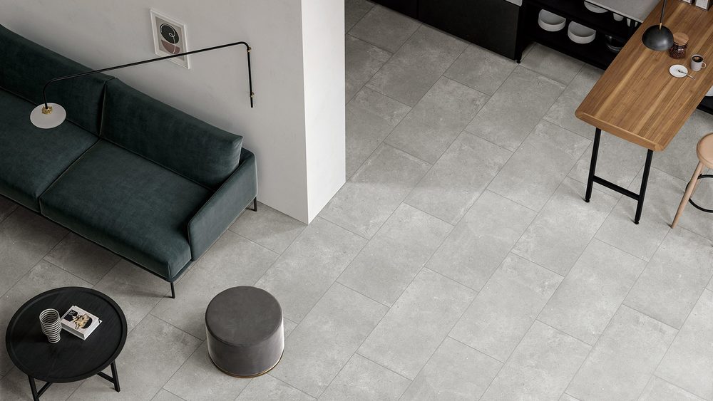 Stoneworld Paradigm light grey concrete-look porcelain floor tiles in an open plan living room