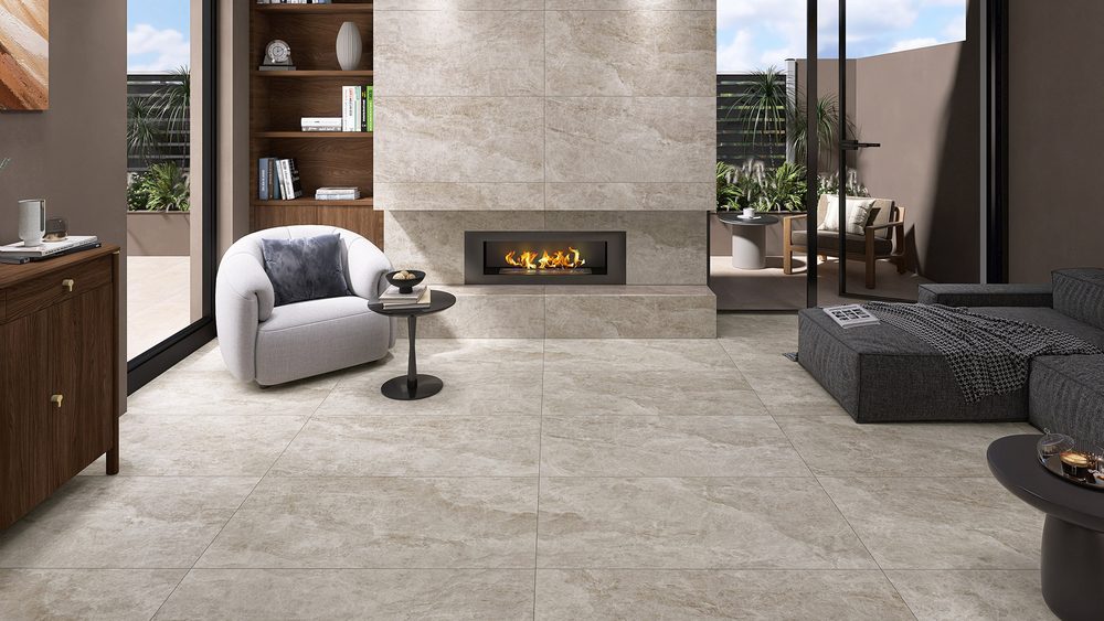 Stoneworld Taj Mahal beige large format porcelain tiles on a living room floor and fireplace wall