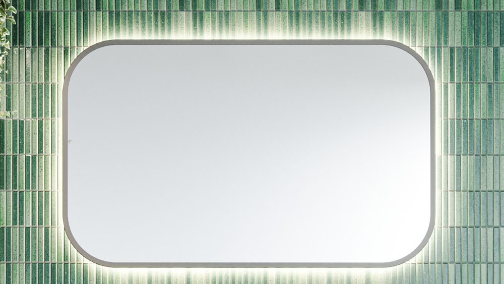 A backlit Timberline Jazz Arch Frame mirror on a green vertical tiled wall