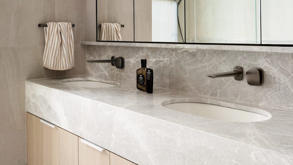 Phoenix Nuage wall mixer set on a stone vanity with a mirror above