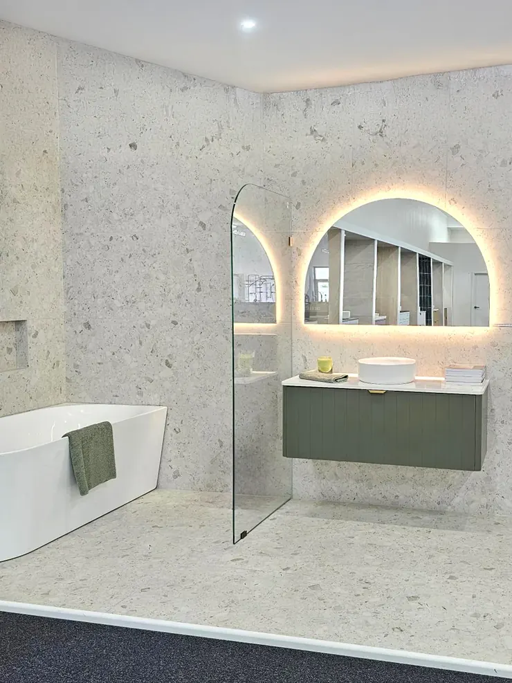Display pod with an olive vanity and stone look tiles