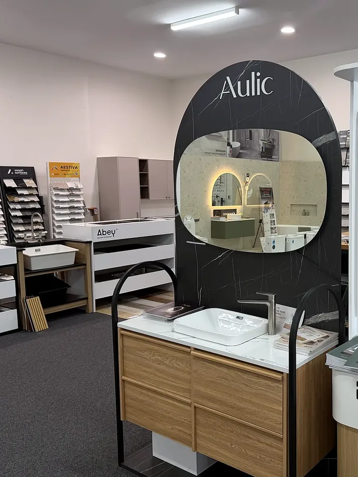 Aulic display in the Osborne Park showroom: a timber look two drawer vanity with a white top and basin under a large backlit mirror