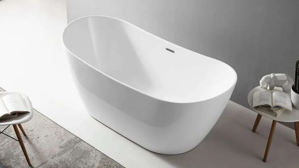 Spazio oval freestanding bath with a high curved back, in a bright room with a pale grey floor