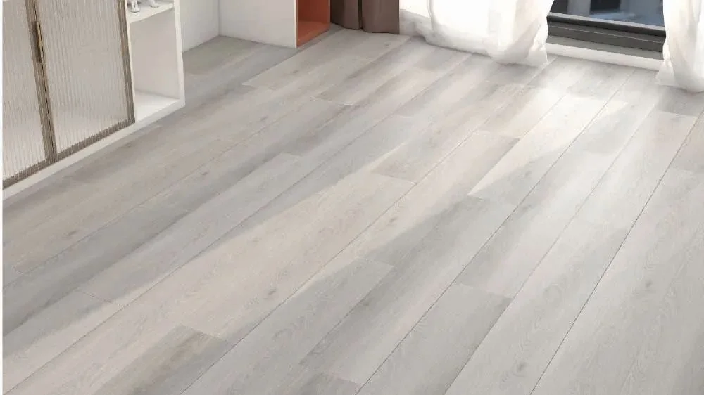 Alpine Pisces SPC hybrid flooring in a pale grey timber look, laid through a bright room