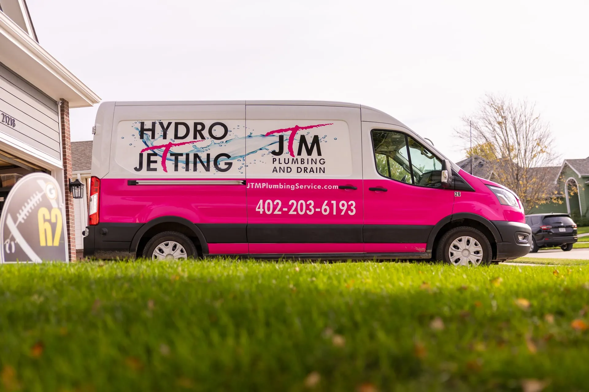 JTM Plumbing and Drain hydro jetting van parked in a residential driveway