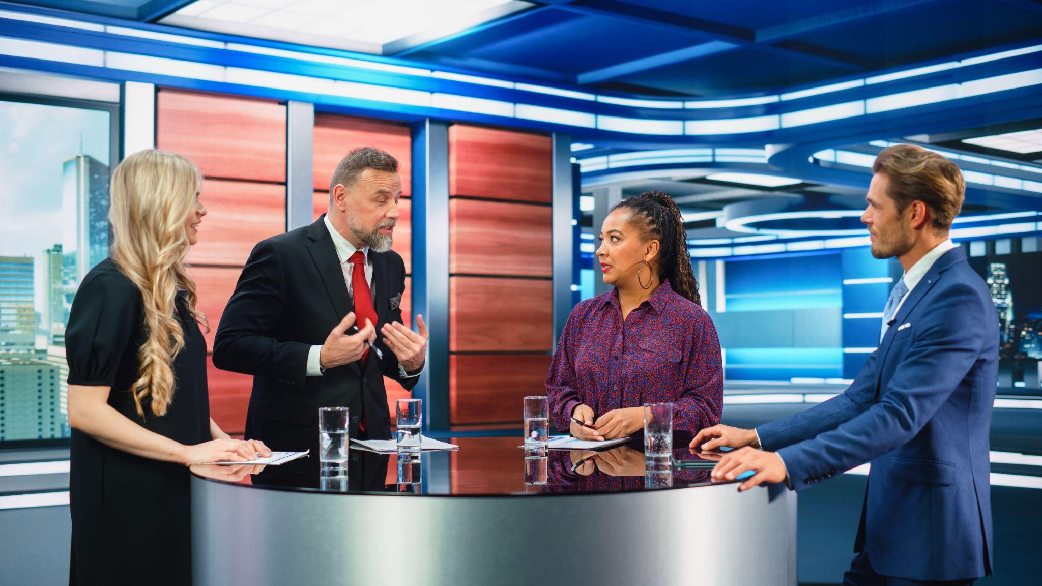Political science students debating claims in a studio-style discussion
