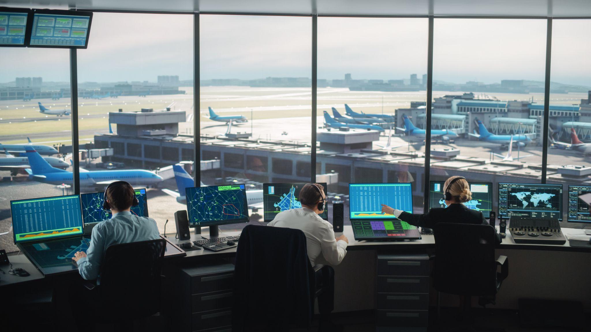 Air traffic controllers monitoring flights at a control tower