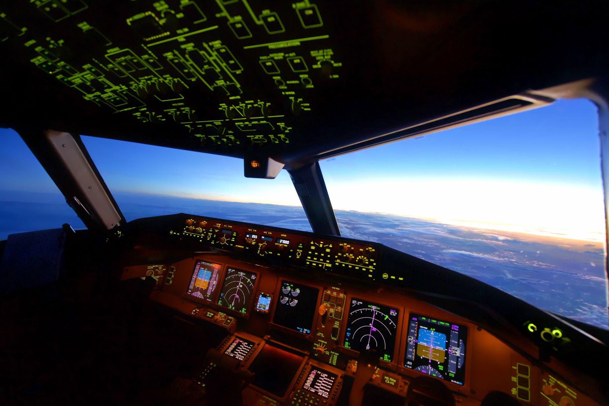 View from an airliner cockpit above the clouds