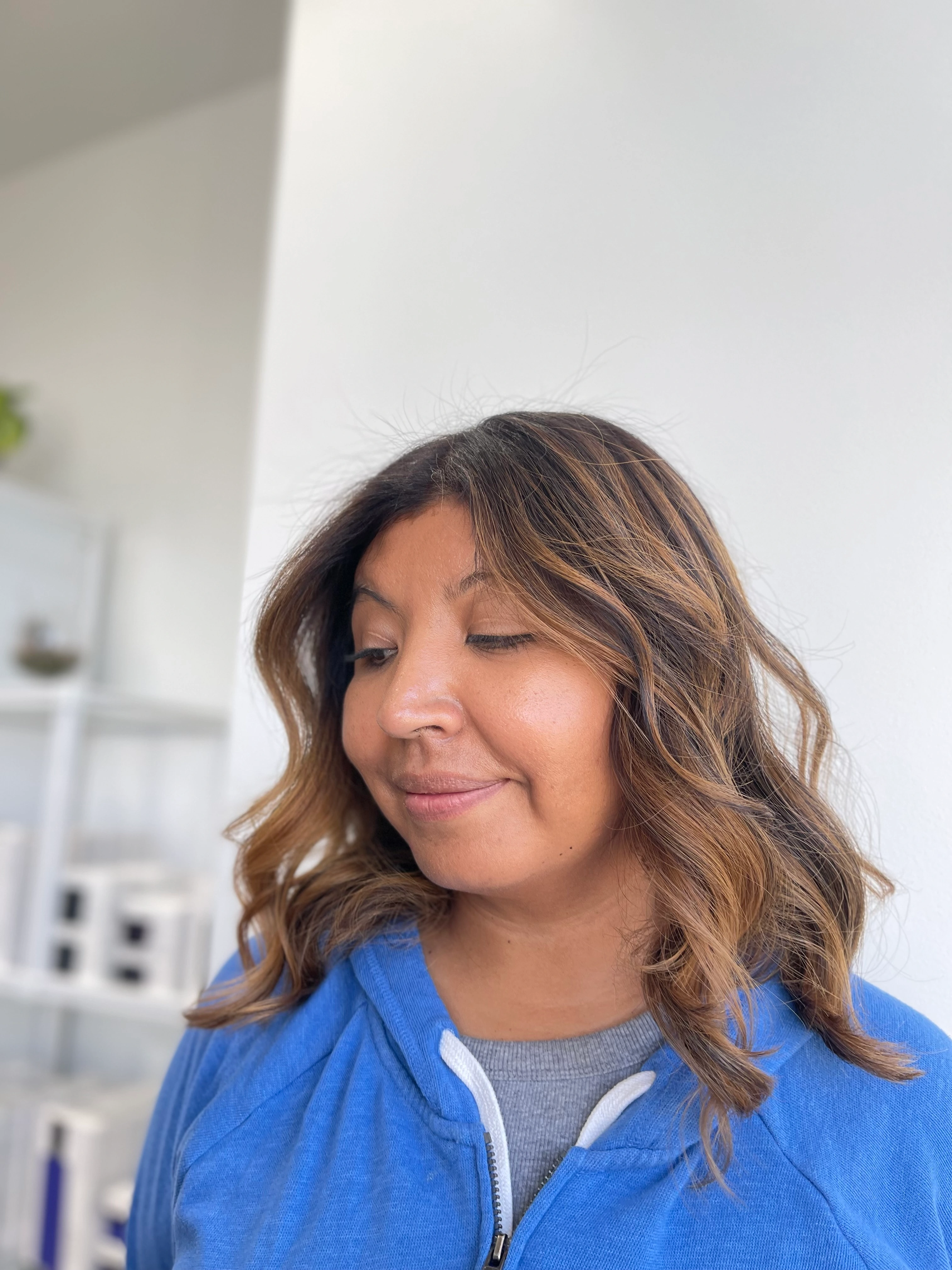 Long layered haircut with movement at Limón Salon San Jose