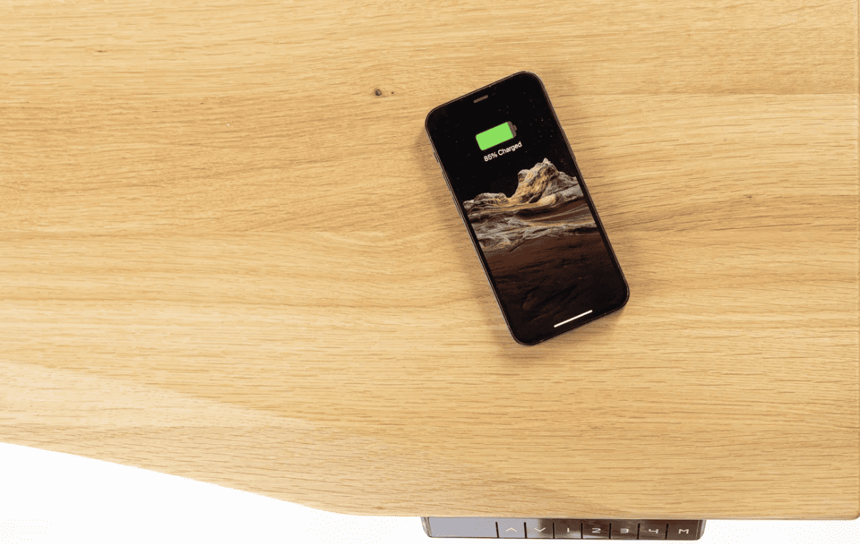 Phone charging on an ErgoHide desk with the hidden wireless charger