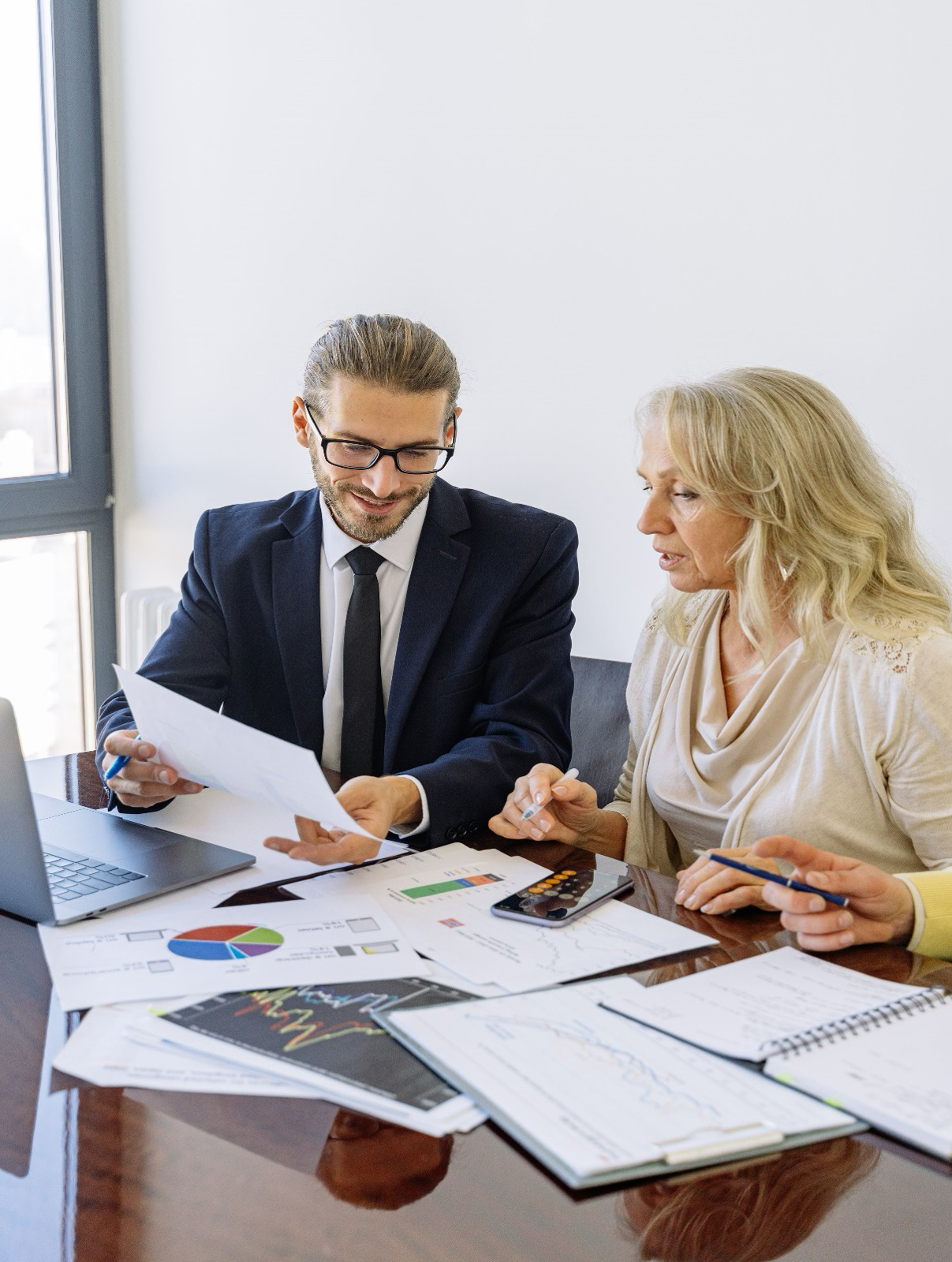 Alt text: A consultant and senior stakeholder examining candidate assessment reports for a public sector executive search.