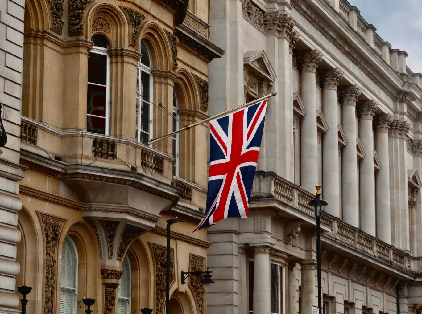 A historic British municipal building displaying the Union Jack flag representing UK leadership in a local government executive search.