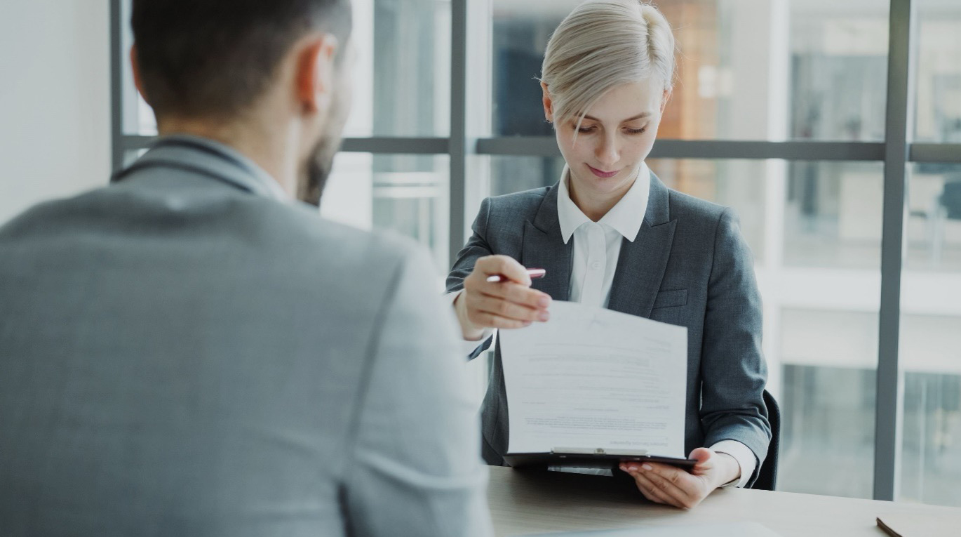 An interviewer reviewing candidate qualifications during a local government executive search assessment process.