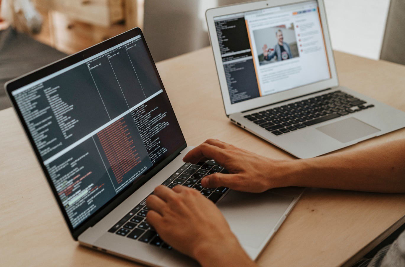 A cybersecurity specialist reviewing code and system configuration on a laptop to support public sector cyber recruitment.