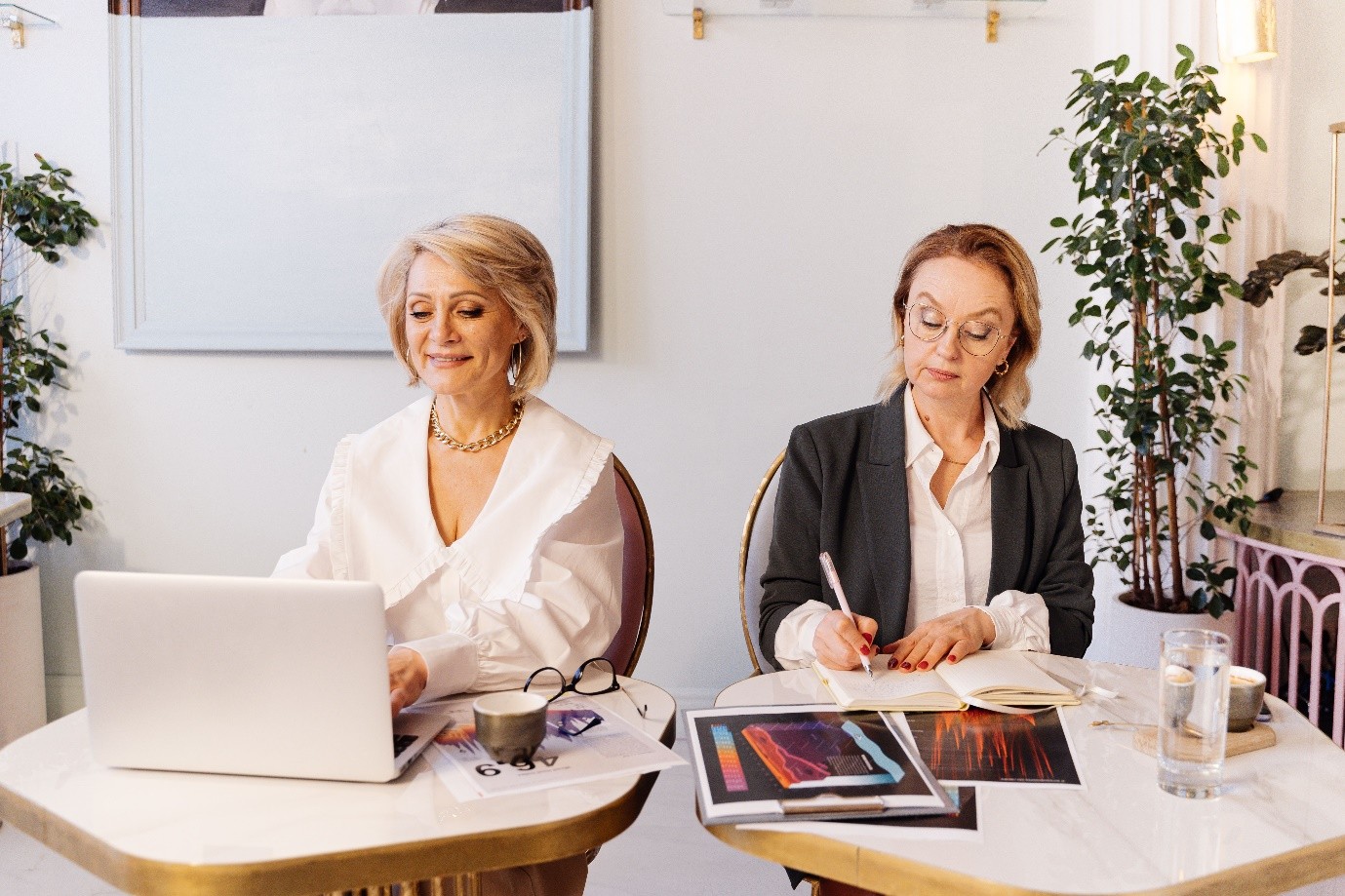 Senior female executives reviewing candidate profiles and compliance frameworks as part of an inclusive senior leadership recruitment process.