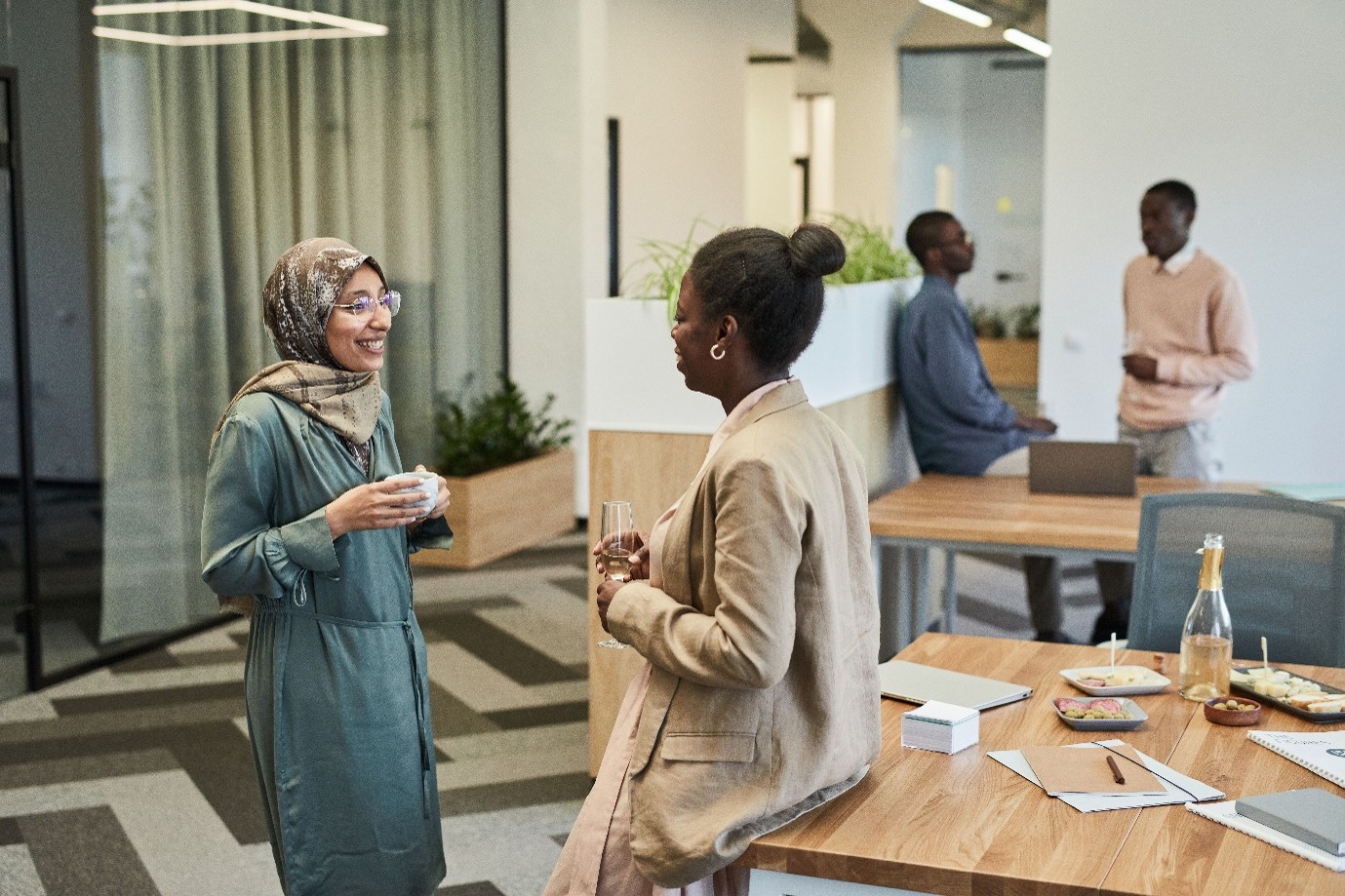 A diverse team of professionals collaborating in a modern office environment to deliver community outcomes under the social value model.   